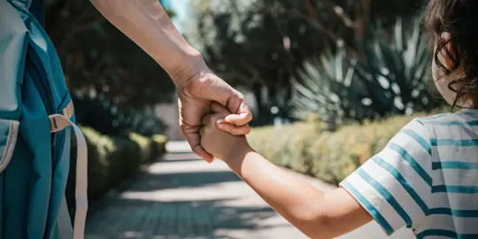 Parent holding hands with child