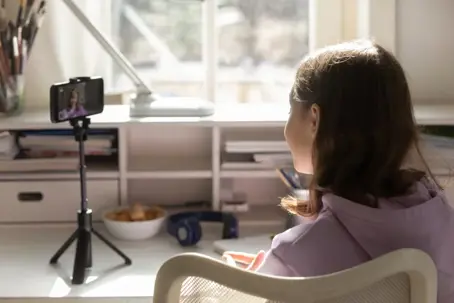 Young girl filming herself on iphone