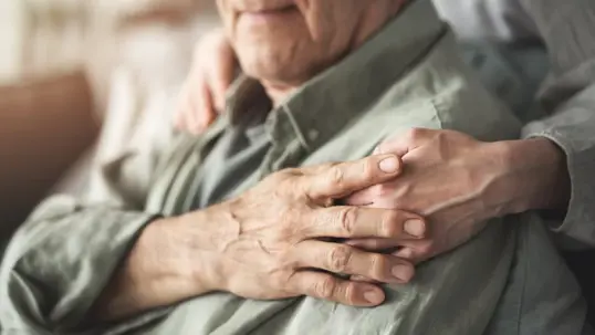 Holding elderly persons hand