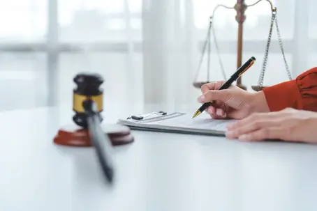 Person writing on a document