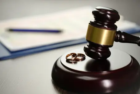 Wedding rings next to gavel