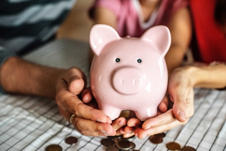 people holding a piggy bank