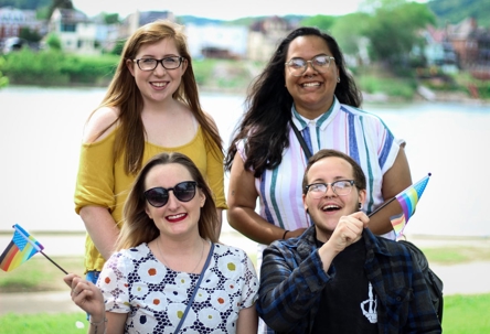 group of four people smiling