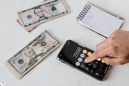 person calculating with money