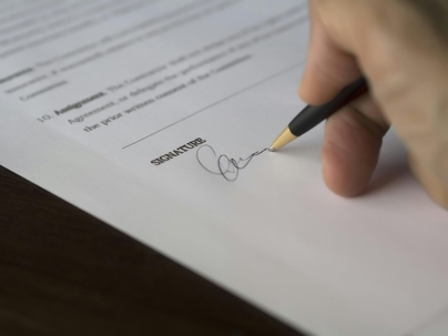 person signing a document