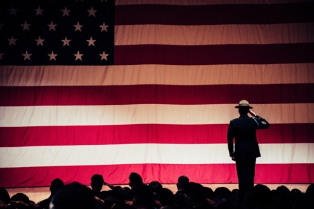 american flag with person saluting in front