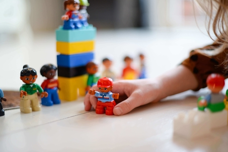 Child Playing with Blocks and Figurines