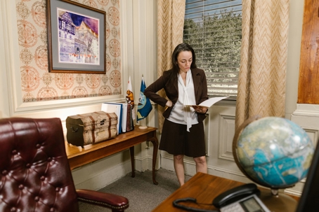 person standing in office looking at paperwork