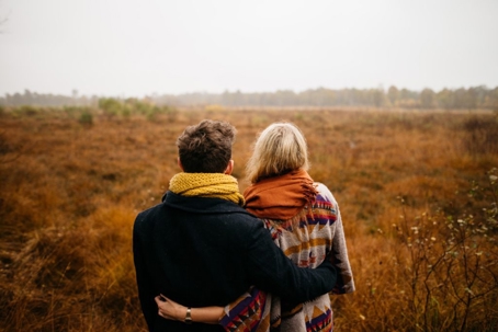 two people sitting in a field