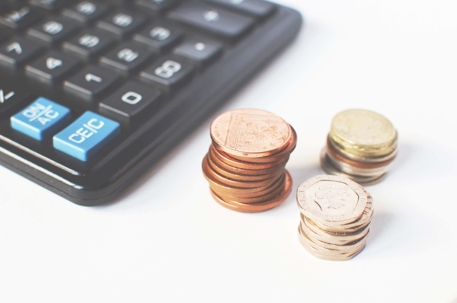 pile of coins near a keyboard