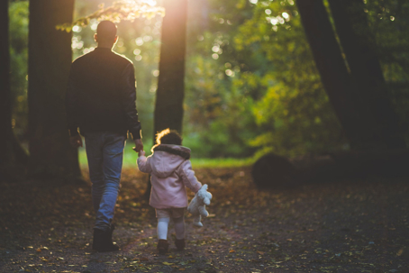 Dad and Child Walking Through Forest