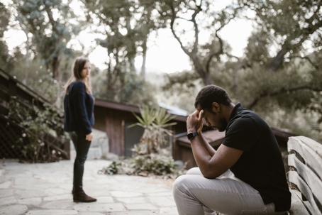 A person upset sitting on a bench