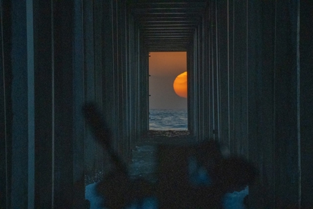 moon showing through a long hallway